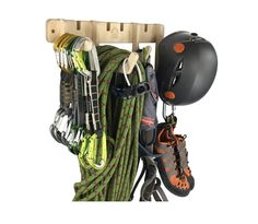 there is a helmet and some climbing gear hanging on the wall