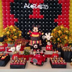 a mickey mouse birthday party with balloons and decorations