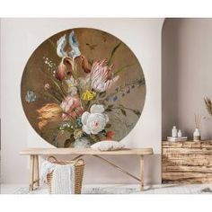 a room with a wooden table and flowers on the wall in front of it,