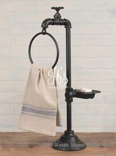 a towel rack with two towels hanging from it's sides on a wooden table