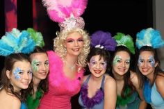 a group of women posing for a photo with their faces painted like bunny ears and feathers