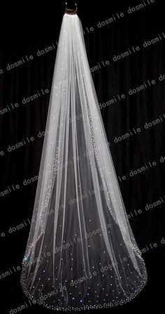 a wedding veil with crystal beads on the bottom is shown in front of a black background