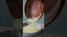 a person pouring yellow liquid into a bowl