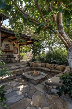 an outdoor living area with stone seating and fire pit