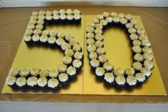 a 50th birthday cake with white frosting and black icing in the shape of the number 50