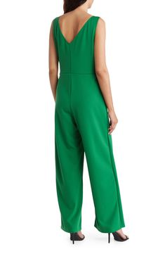 Set the trend in this sleeveless crepe jumpsuit featuring an attached belt with a sparkling buckle and elegant leg overlays. V-neck Sleeveless Unlined 96% polyester, 4% spandex Hand wash, line dry Made in the USA Model stats: 5'10" height, 32" bust, 25" waist, 36" hip. Model is wearing size Small. Sleeveless Belted Formal Jumpsuit, Sleeveless Belted Formal Jumpsuits And Rompers, Sleeveless Belted Jumpsuit For Formal Occasions, Green Sleeveless Jumpsuits And Rompers For Evening, Formal Belted Sleeveless Jumpsuits And Rompers, Green Sleeveless Jumpsuits For Evening, Sleeveless Belted Jumpsuits And Rompers For Evening, Belted Strapless Jumpsuit For Workwear, Belted Strapless Sleeveless Jumpsuit