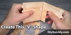 two hands holding pieces of wood with the words create this v shape