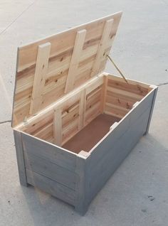 an open wooden box sitting on the ground