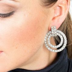 Add some sparkle to your season in our Kenneth Jay Lane Crystal Door Knocker Clip Earrings. These beautiful designer Kenneth Jay Lane doorknocker earrings are set in polished rhodium and finished with stunning crystal pave stones. Perfect for special events and more. A must have for cocktail season. Clip on 1.5" L Made in the USA SKU: KJL-1DRKC Glamorous Diamond Sparkling Hoop Earrings, Party Diamond Earrings With Cubic Zirconia, Glamorous Diamond Hoop Earrings For Party, Elegant Bling Hoop Earrings For Evening, Modern Crystal Earrings For Party, Elegant Evening Hoop Earrings With Bling, Dazzling Diamond Earrings With Accents For Party, Dazzling Diamond Accent Earrings For Party, Diamond White Diamond Hoop Earrings For Party