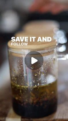 a jar filled with liquid sitting on top of a wooden table