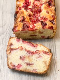 a loaf of strawberry bread sitting on top of a wooden table