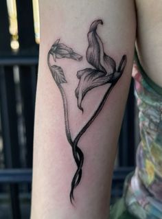 a woman's arm with a flower tattoo on the left side of her body