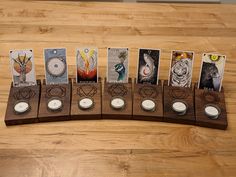 an array of cards and candles on a wooden table with white wax in the middle