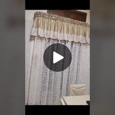 a bathroom with a shower curtain, toilet and bathtub in the background is an image of a video screen showing how to make a ruffled shower curtain