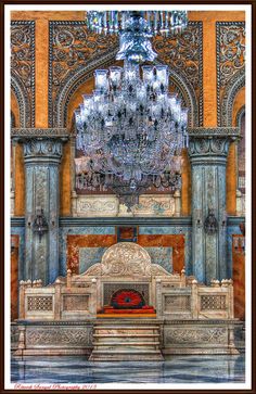 an ornate alter with chandelier in the background