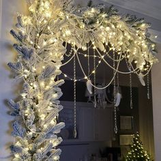 a white christmas tree decorated with lights and snowflakes