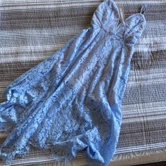 Perfect For Wedding Season! This Blue Lace Handkerchief Hem Midi Dress Is The Quintessential Dress For Any Occasion. Blue Lace Trim Dress For Prom, Blue Lace Trim Prom Dress, Blue Prom Dress With Lace Trim, Sleeveless Blue Lace Prom Dress, Spring Blue Lace Prom Dress, Blue Lace Dress For Spring Wedding Guest, Blue Lace Bridesmaid Dress, Blue Lace Trim Dress For Wedding, Light Blue Lace V-neck Dress