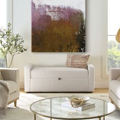 a living room filled with furniture and a painting on the wall