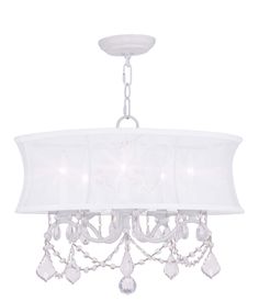 a chandelier with white shades and crystal drops hanging from the ceiling, on a white background