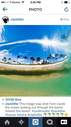 an aerial view of the ocean with palm trees in the water and blue sky above