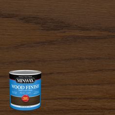 a can of wood finish sitting on top of a wooden table