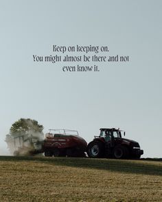 two trucks driving down a road next to each other on top of a grass covered field