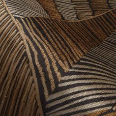 an up close view of a brown and black pattern on the side of a chair