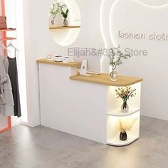 a white counter sitting in front of a mirror and shelf with vases on it