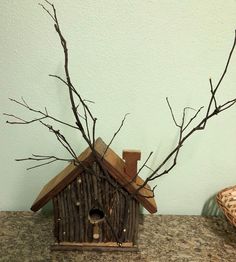 a birdhouse made out of wood and branches