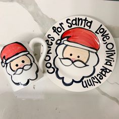 two plates with santa's faces painted on them, one is white and the other is red