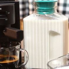 a bottle of milk sitting next to a blender