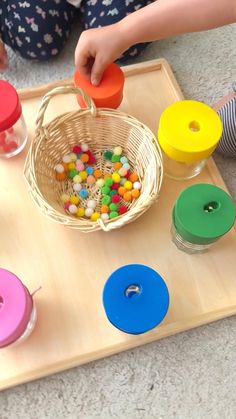 a child is playing with toys on the floor in front of their play trays