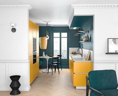 a kitchen with yellow cabinets and green chairs in it's center area, next to a dining room table