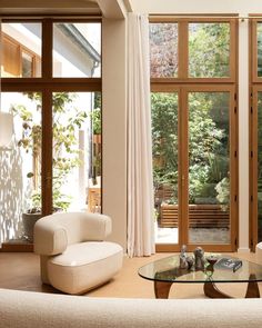 a living room filled with furniture and lots of windows