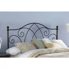 a black metal headboard with scroll design