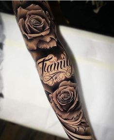 a man's arm with roses and the words family on it