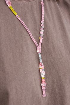 Pullover beaded necklace 16" drop, 24" opening One of a kind Made of glass beads Lift over head with care Handmade in Boulder, CO Designer: Salihah Moore | Learn more about the Designer and shop the collection. Long Pink Necklace With Large Beads, Pink Long Necklace With Large Beads, Pink Large Beaded Long Necklace, Lariat Necklace With 108 Beads, Pink Long Beaded Necklace, Salihah Moore, Beaded Necklace Outfit, Purple Bead Necklace, Boulder Co