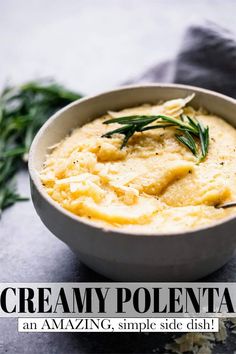 a white bowl filled with creamy polenta and topped with fresh herbs on the side