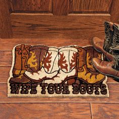 a cowboy boot rug on the floor next to a pair of boots