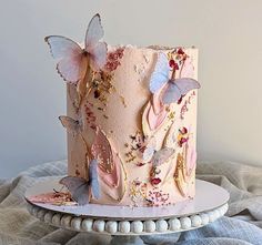 there is a pink cake with butterflies on it