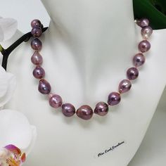 Beautiful one of a kind cultured Edison Pearl necklace. These freshwater baroque pearls are so  rich in color (deep purplish pink color), some surface texture but still smooth and with high luster. Hand knotted, graduated in size (11-13.5mm), total length is 18 inches and finished with a sterling silver rhodium plated clasp. This is truly a fabulous necklace, outstanding color with amazing luster.  In order to create unique and distinctive pieces, I use diverse shapes of natural gems to ensure t Elegant Purple Pearl Necklace, Purple Single Strand Pearl Necklace, Handmade Elegant Purple Pearl Necklace, Pearl Lariat, Edison Pearls, Golden South Sea Pearls, Larimar Jewelry, Pearl Strand, Pearl Strands