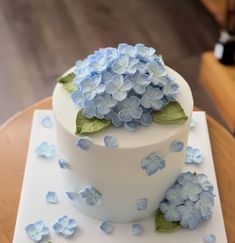 there is a white cake with blue flowers on it