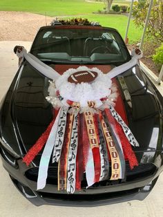 a car decorated with ribbon and football decorations