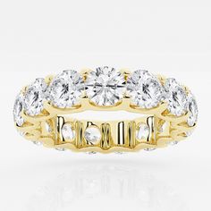 a yellow gold ring with three rows of round cut diamonds in the center and sides