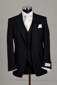 a black suit with white shirt and tie