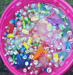 a pink tub filled with lots of different types of sodas and water in it