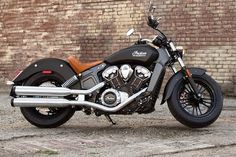 a motorcycle parked in front of a brick wall