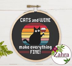 a cross stitch pattern with a cat saying cats and wine make everything fine on it