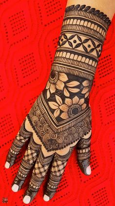 a hand with henna tattoos on it