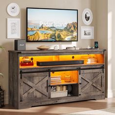 a flat screen tv mounted to the side of a wooden entertainment center in a living room